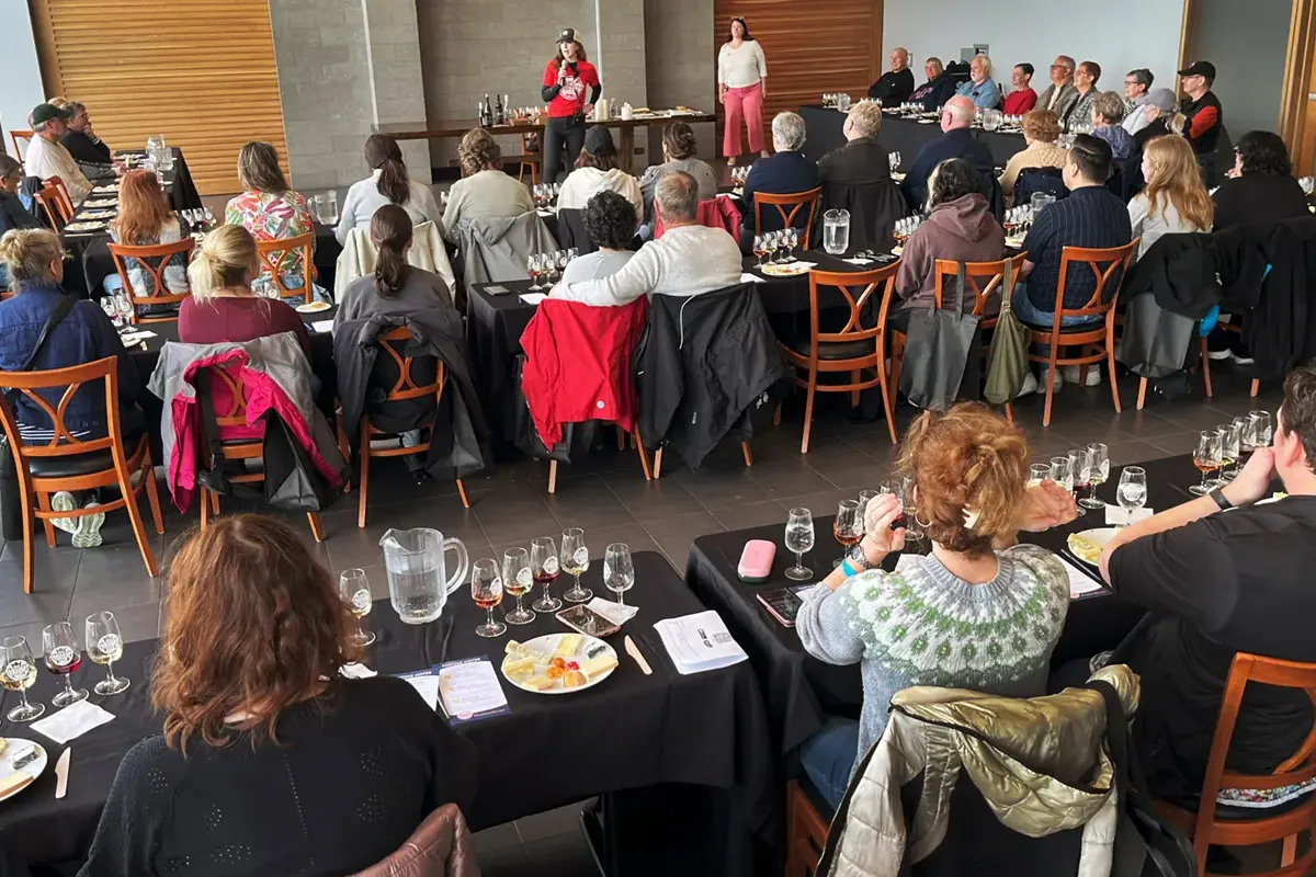 Full room of festival guests participating in a guided cheese tasting and pairing seminar